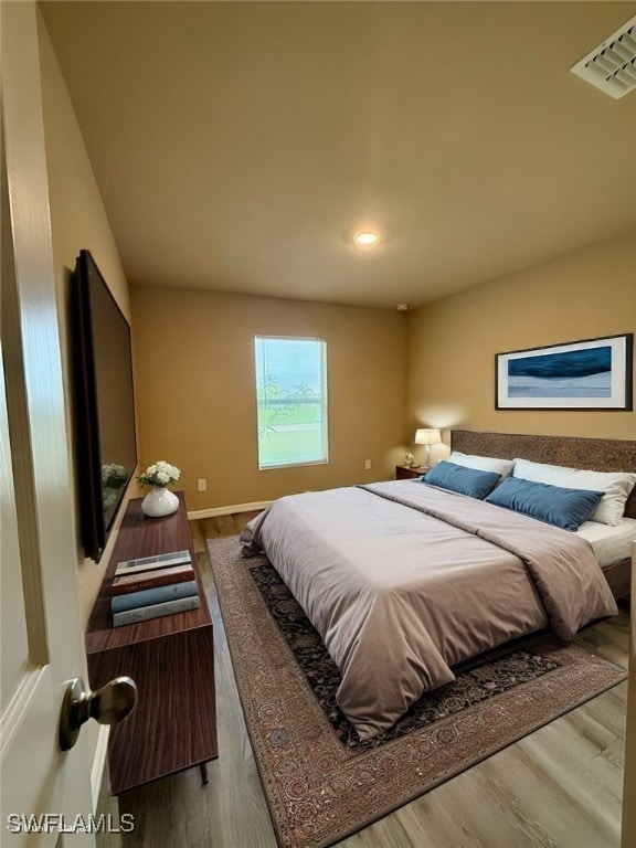 bedroom with hardwood / wood-style floors