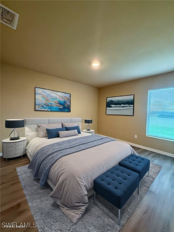 bedroom with hardwood / wood-style floors