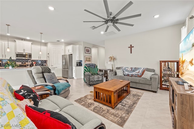 living room featuring light tile patterned flooring and ceiling fan