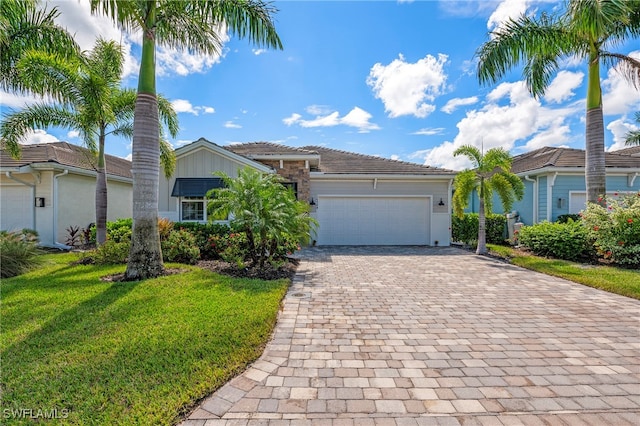 view of front of home featuring a front lawn and a garage