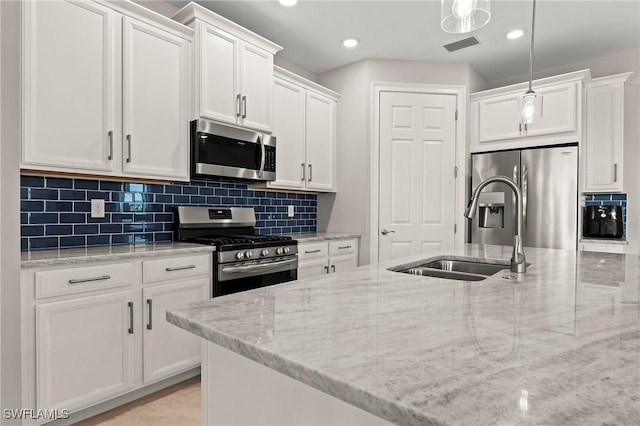 kitchen with a sink, stainless steel appliances, visible vents, and white cabinetry