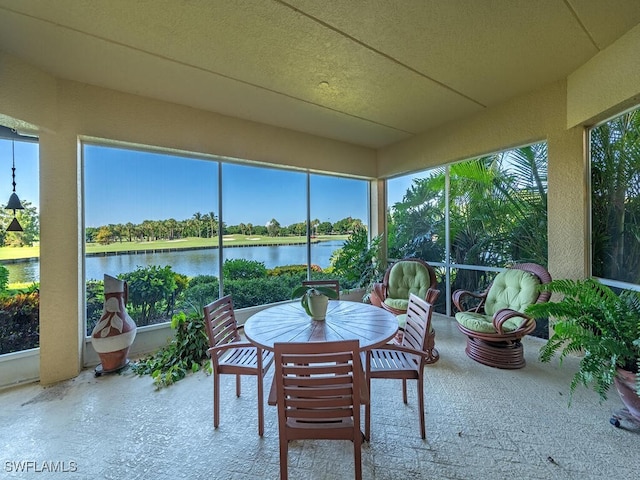 sunroom / solarium with a water view and plenty of natural light