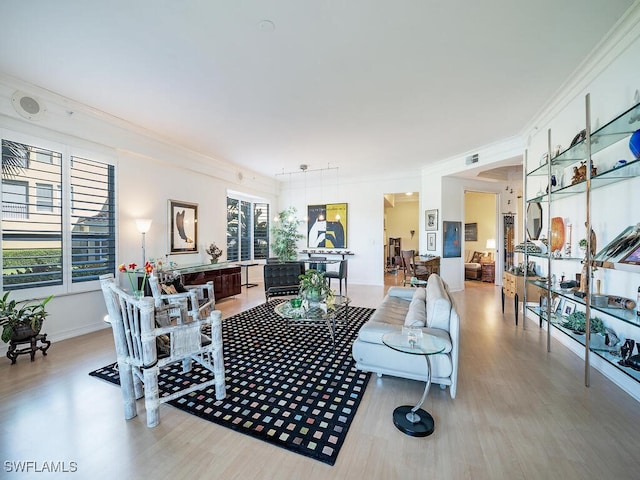 living room featuring ornamental molding and hardwood / wood-style flooring