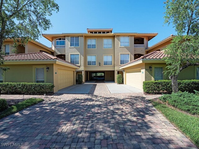 view of front of property with a garage and a balcony