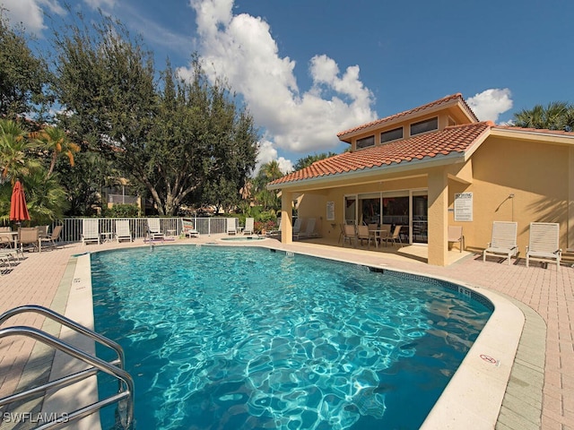 view of swimming pool featuring a patio area