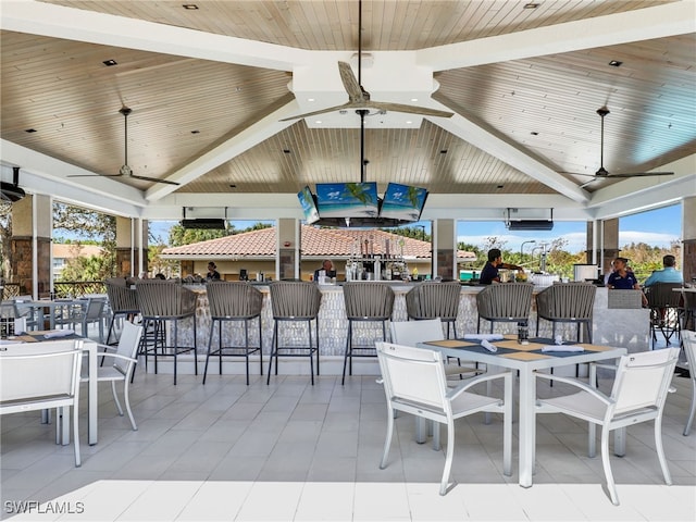 view of patio / terrace featuring ceiling fan and exterior bar