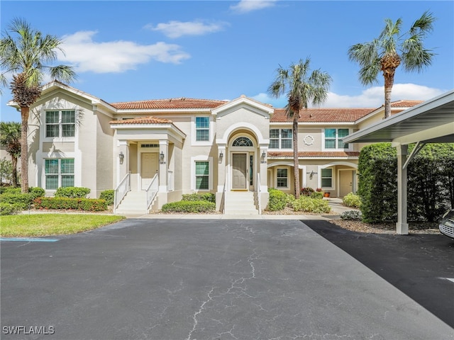 mediterranean / spanish house featuring a tiled roof and stucco siding