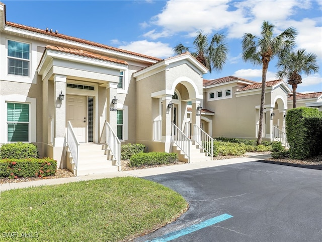 mediterranean / spanish house with a front yard