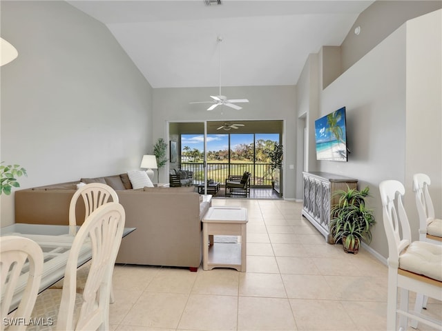 tiled living room featuring high vaulted ceiling and ceiling fan