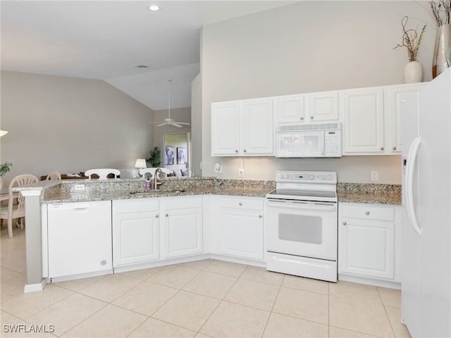 kitchen with white cabinets, sink, vaulted ceiling, and white appliances