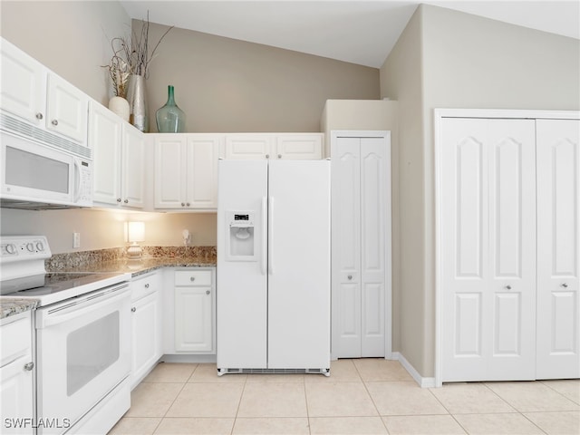 kitchen featuring white cabinets, light tile patterned floors, vaulted ceiling, and white appliances