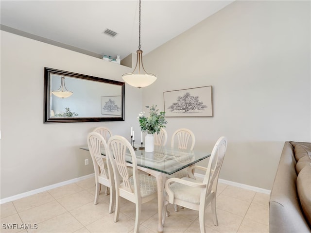 tiled dining area with vaulted ceiling