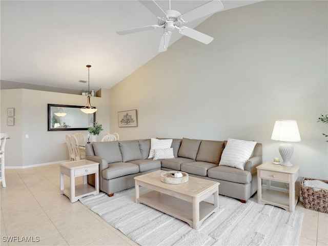 living room with lofted ceiling, light tile patterned floors, and ceiling fan