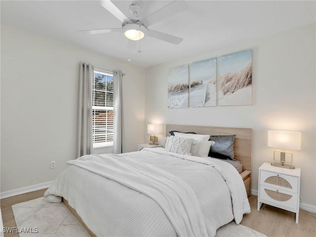 bedroom with light wood-type flooring and ceiling fan