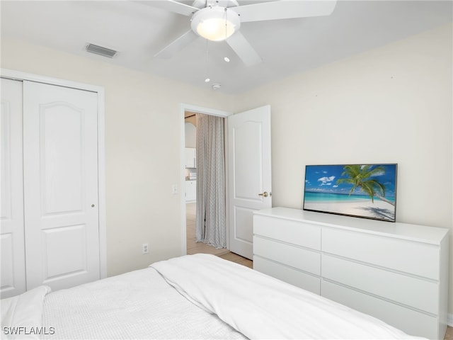 bedroom featuring light wood-type flooring, a closet, and ceiling fan