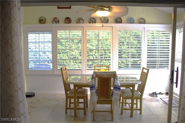 tiled dining area with ceiling fan