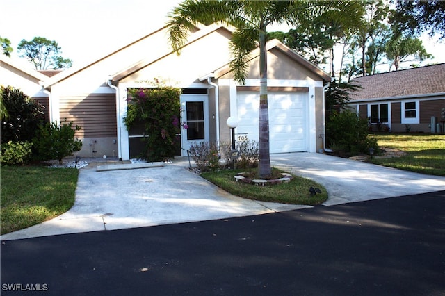 single story home with a front yard and a garage