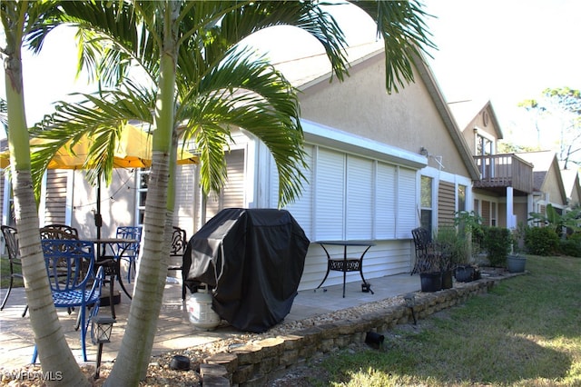 view of home's exterior featuring a patio and a balcony