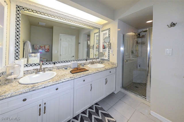 bathroom featuring vanity, a shower with door, and tile patterned floors