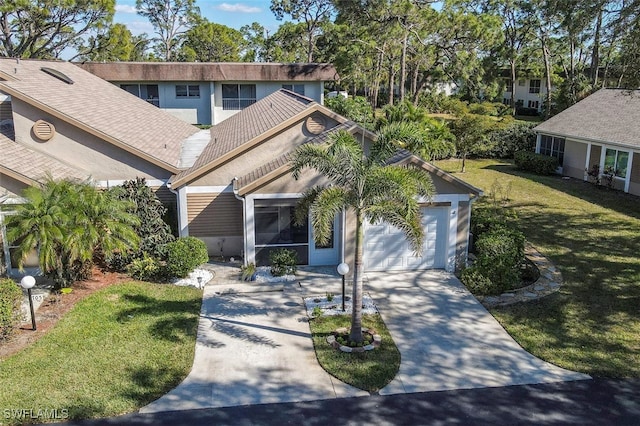 view of front of property featuring a garage and a front lawn