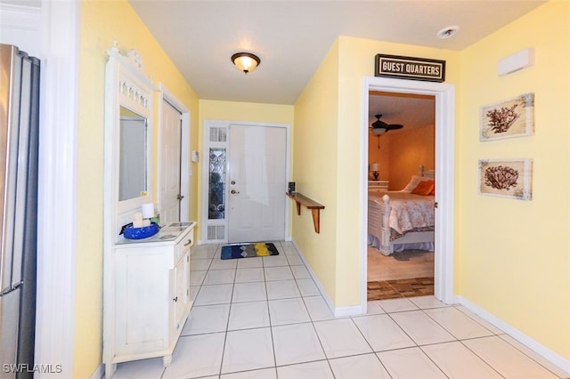 interior space featuring light tile patterned floors and ceiling fan