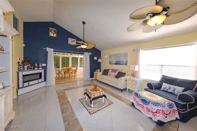 tiled living room featuring vaulted ceiling and ceiling fan