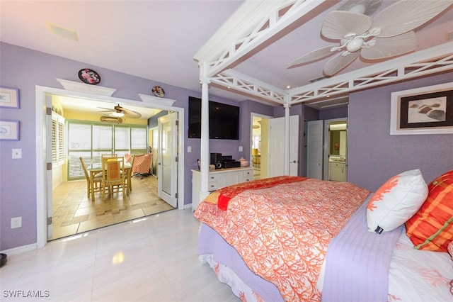 bedroom featuring connected bathroom, light tile patterned floors, and ceiling fan