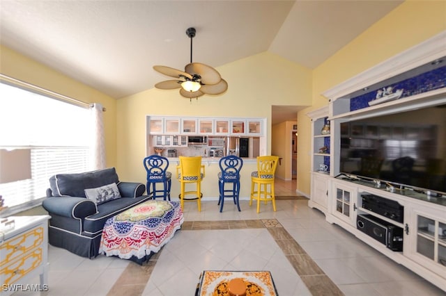 tiled living room featuring ceiling fan and lofted ceiling