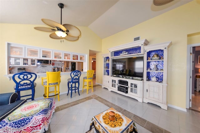 tiled living room featuring lofted ceiling and ceiling fan