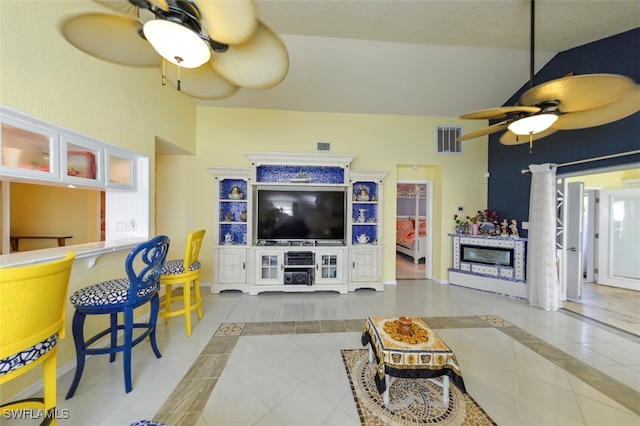 tiled living room featuring lofted ceiling and ceiling fan