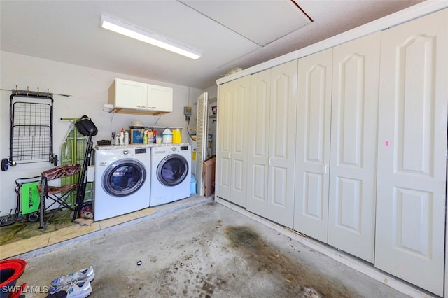 laundry room with cabinets and washer and dryer