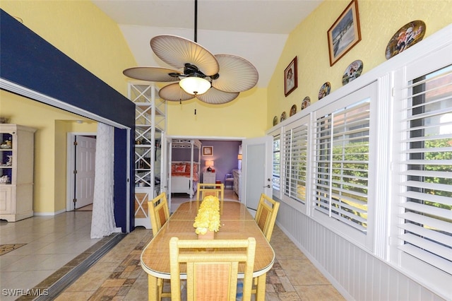 dining area featuring a high ceiling, plenty of natural light, and ceiling fan