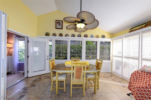 dining space featuring ceiling fan and high vaulted ceiling