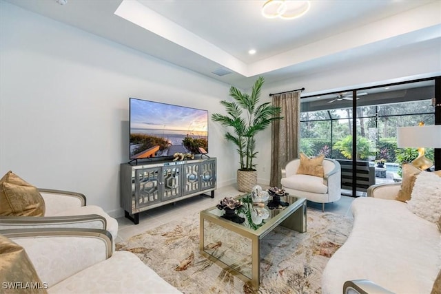 tiled living room featuring a tray ceiling