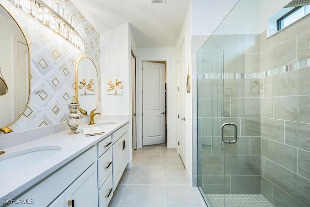 bathroom featuring tile patterned floors, a shower with shower door, and vanity