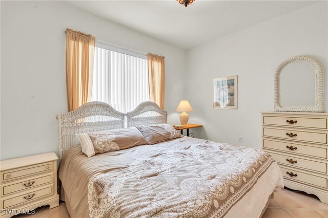 bedroom with light tile patterned floors