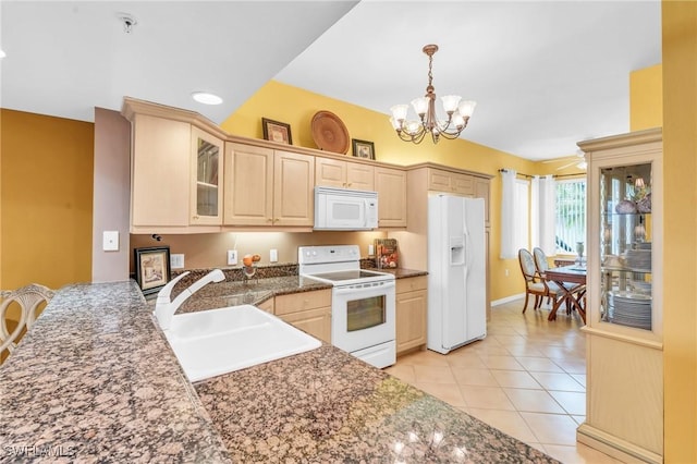 kitchen featuring light brown cabinets, white appliances, an inviting chandelier, and sink