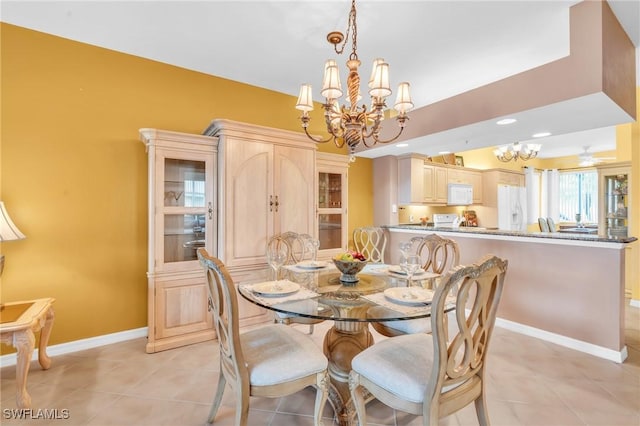 tiled dining space with a chandelier