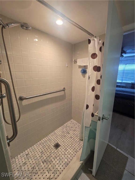 bathroom with tile patterned floors and walk in shower