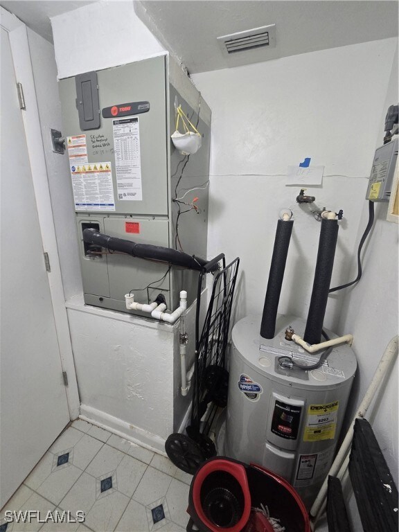 utility room featuring electric water heater