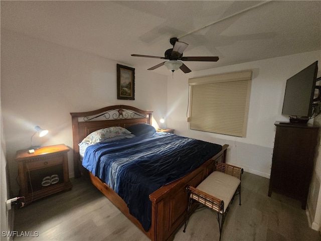 bedroom with ceiling fan and wood-type flooring