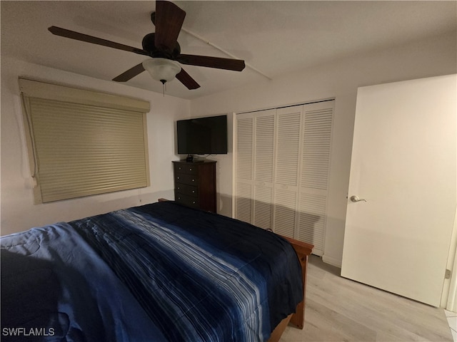 bedroom featuring ceiling fan, hardwood / wood-style flooring, and a closet