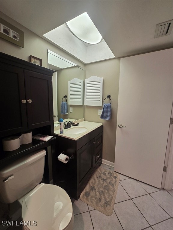 bathroom with tile patterned floors, vanity, and toilet