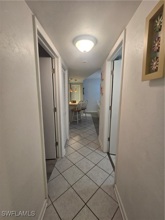 hall with light tile patterned floors