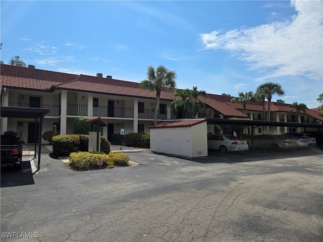 view of front of house featuring a carport and a balcony