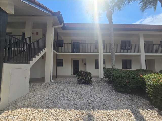 back of property featuring a balcony