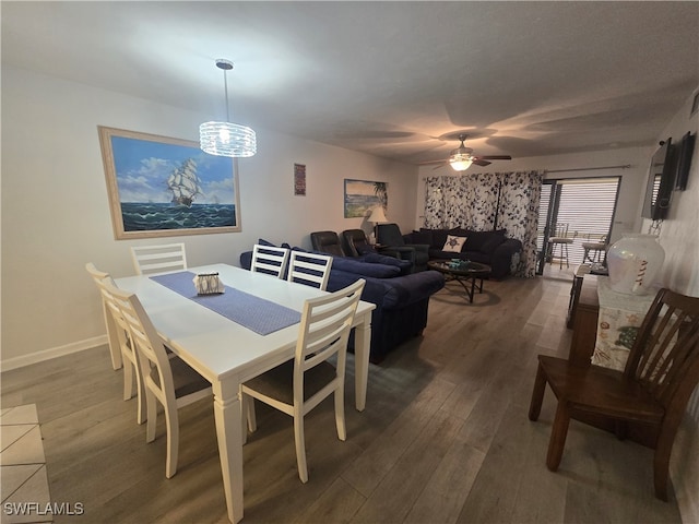 dining area with ceiling fan and dark hardwood / wood-style flooring