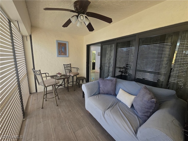 sunroom with ceiling fan and a wealth of natural light