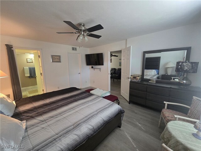 bedroom featuring ceiling fan, connected bathroom, and hardwood / wood-style floors