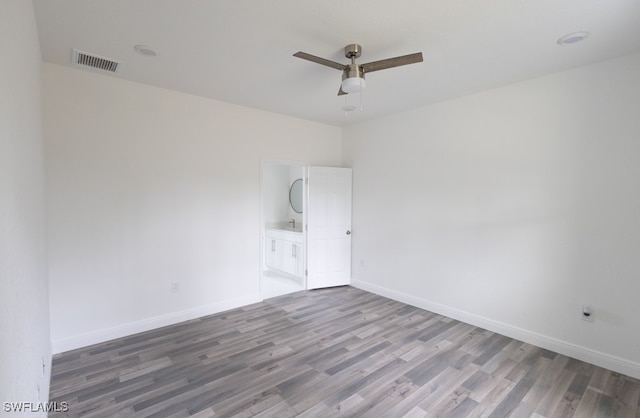 spare room with hardwood / wood-style flooring and ceiling fan